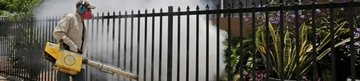 Mosquito control technician fogging a yard perimeter for mosquito reduction in Knoxville, TN
